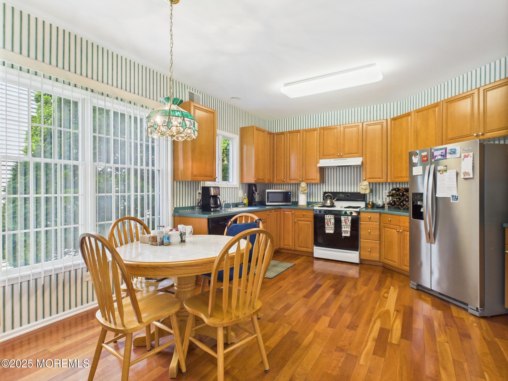 10 Windward Way Red Bank, NJ 07701 - Photo 6 of 31 a kitchen with stainless steel appliances wooden floors and wooden cabinets