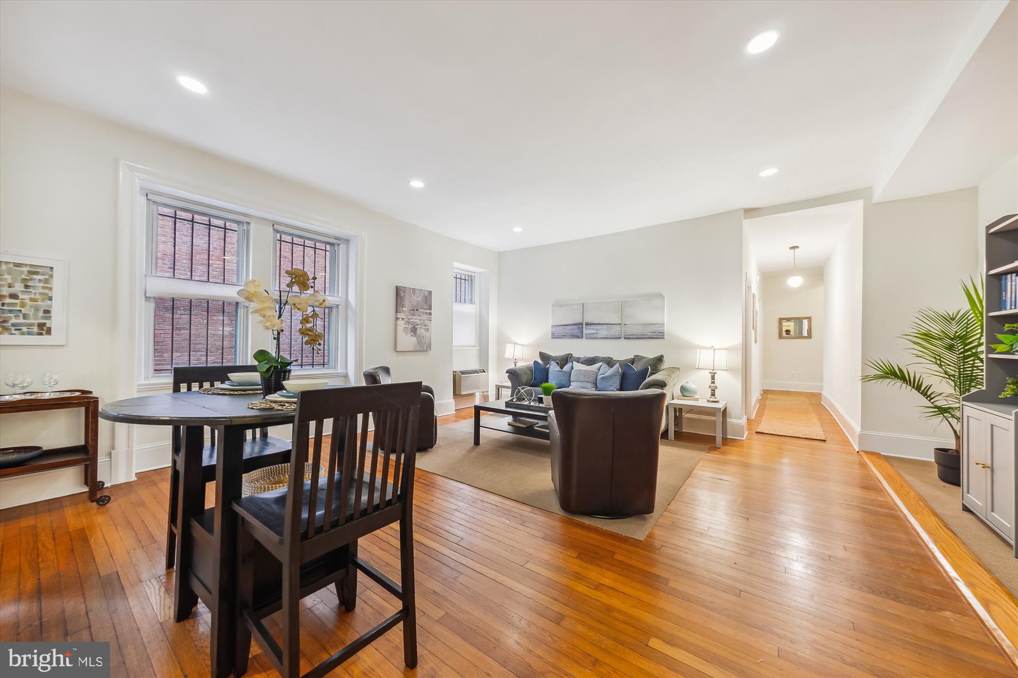 a living room with furniture wooden floor and a window