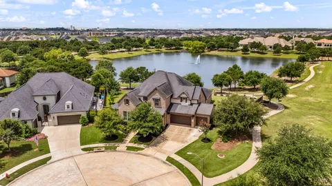 an aerial view of a house with a garden and lake view