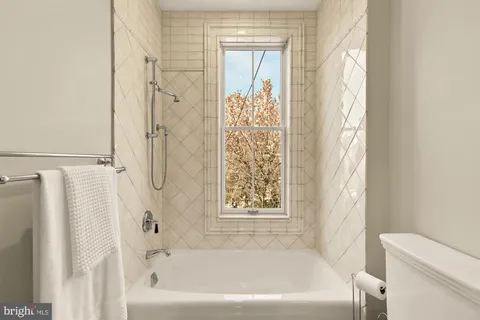 a bathroom with a bathtub and shower