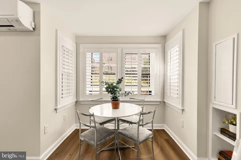 a view of a dining room with furniture window and wooden floor
