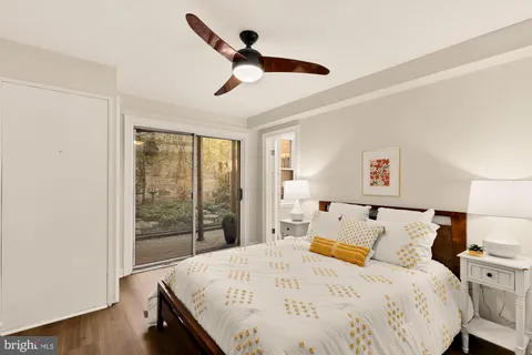 a bedroom with a bed and a large window