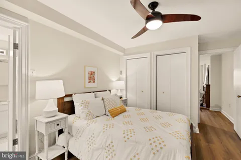 a bedroom with a bed and wooden floor