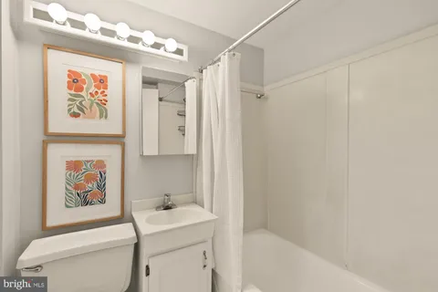 a bathroom with a sink mirror vanity and toilet