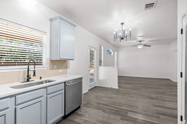 a kitchen with a sink cabinets and window