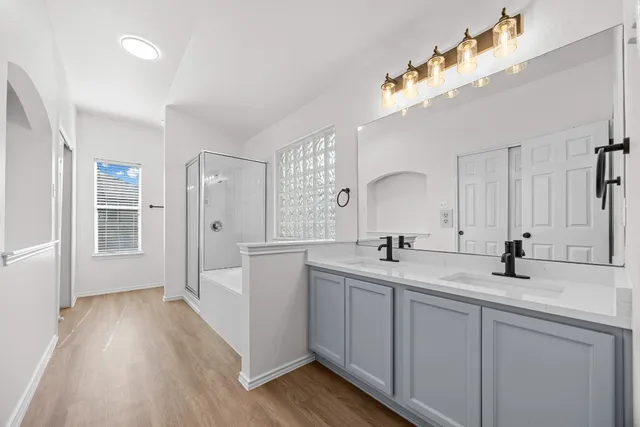 a kitchen with a sink cabinets and wooden floor