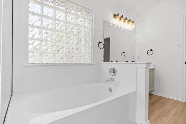 a bathroom with a bathtub and a shower