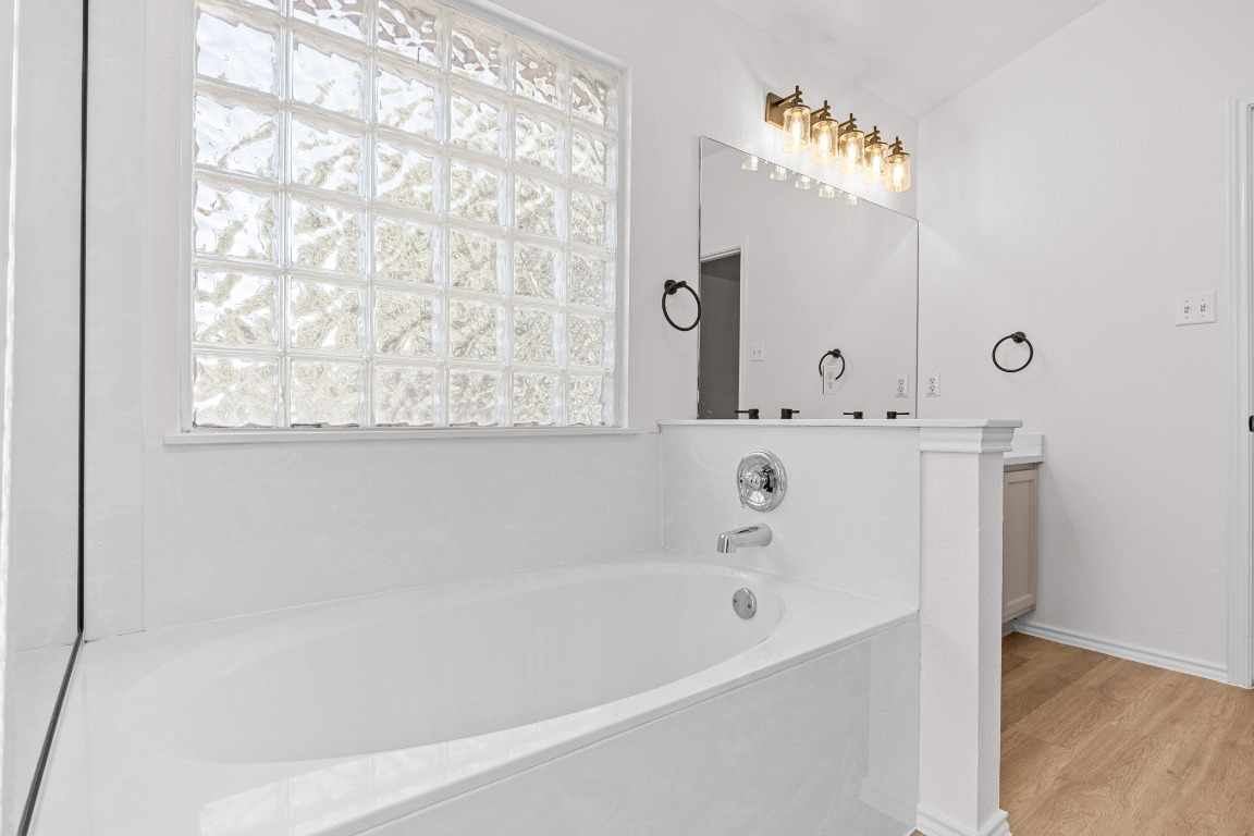 10208 Laredo Drive, Unit 105 Austin, TX 78748 - Photo 27 of 37 a bathroom with a bathtub and a shower