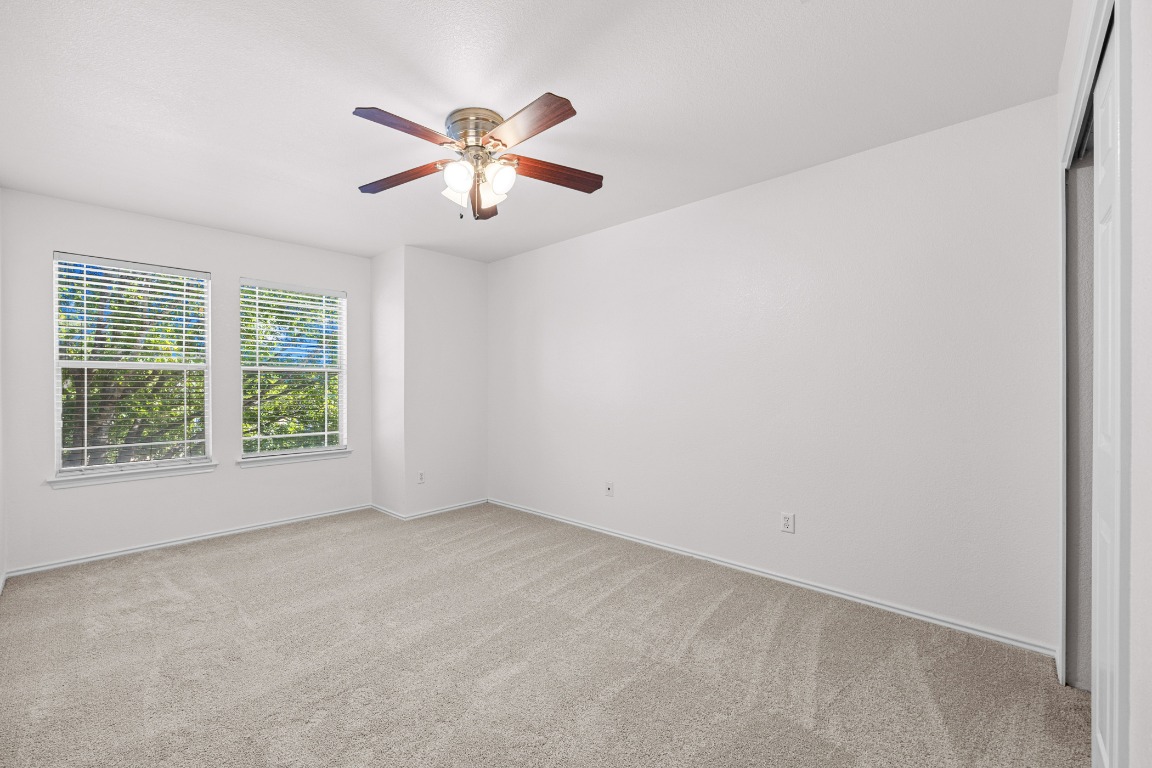 10208 Laredo Drive, Unit 105 Austin, TX 78748 - Photo 31 of 37 an empty room with windows and fan