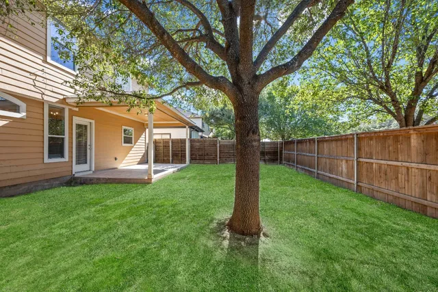 a view of a house with a backyard