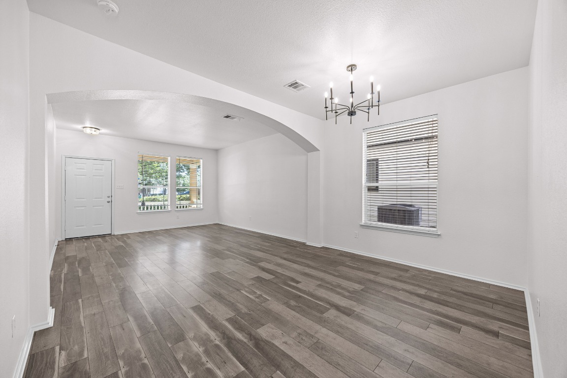 10208 Laredo Drive, Unit 105 Austin, TX 78748 - Photo 8 of 37 a view of an empty room with a window and wooden floor
