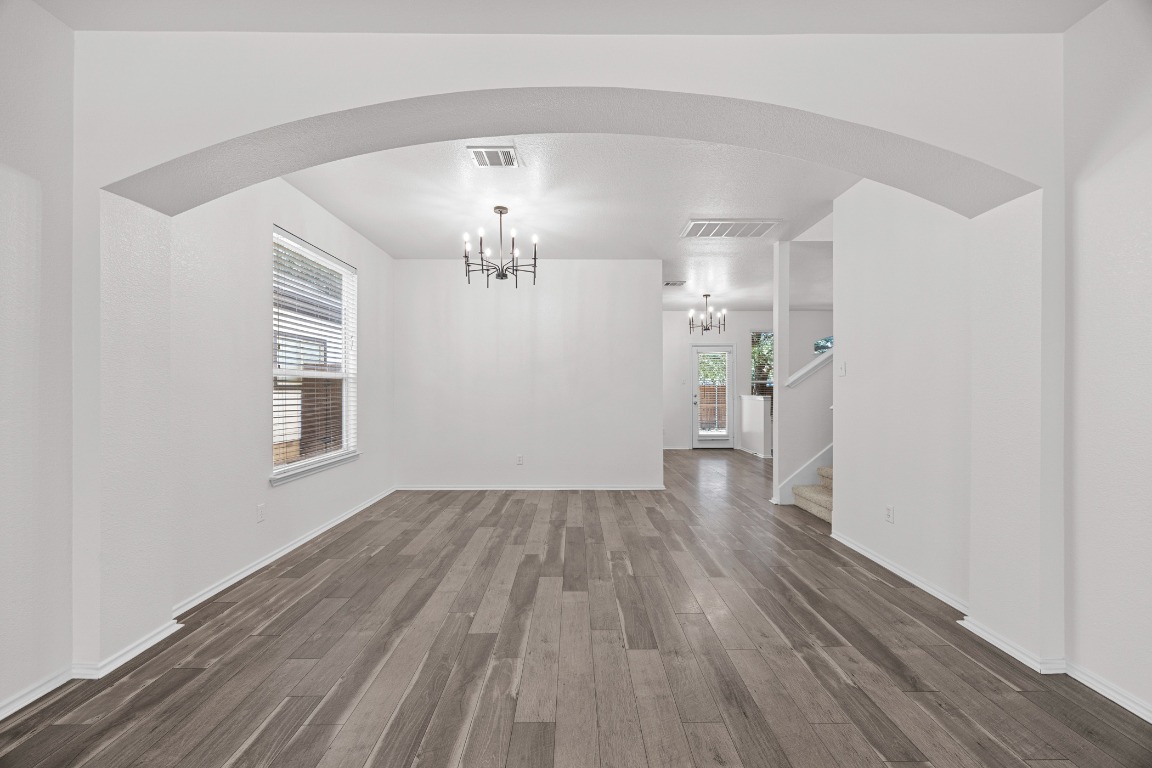 10208 Laredo Drive, Unit 105 Austin, TX 78748 - Photo 9 of 37 wooden floor in an empty room with a window