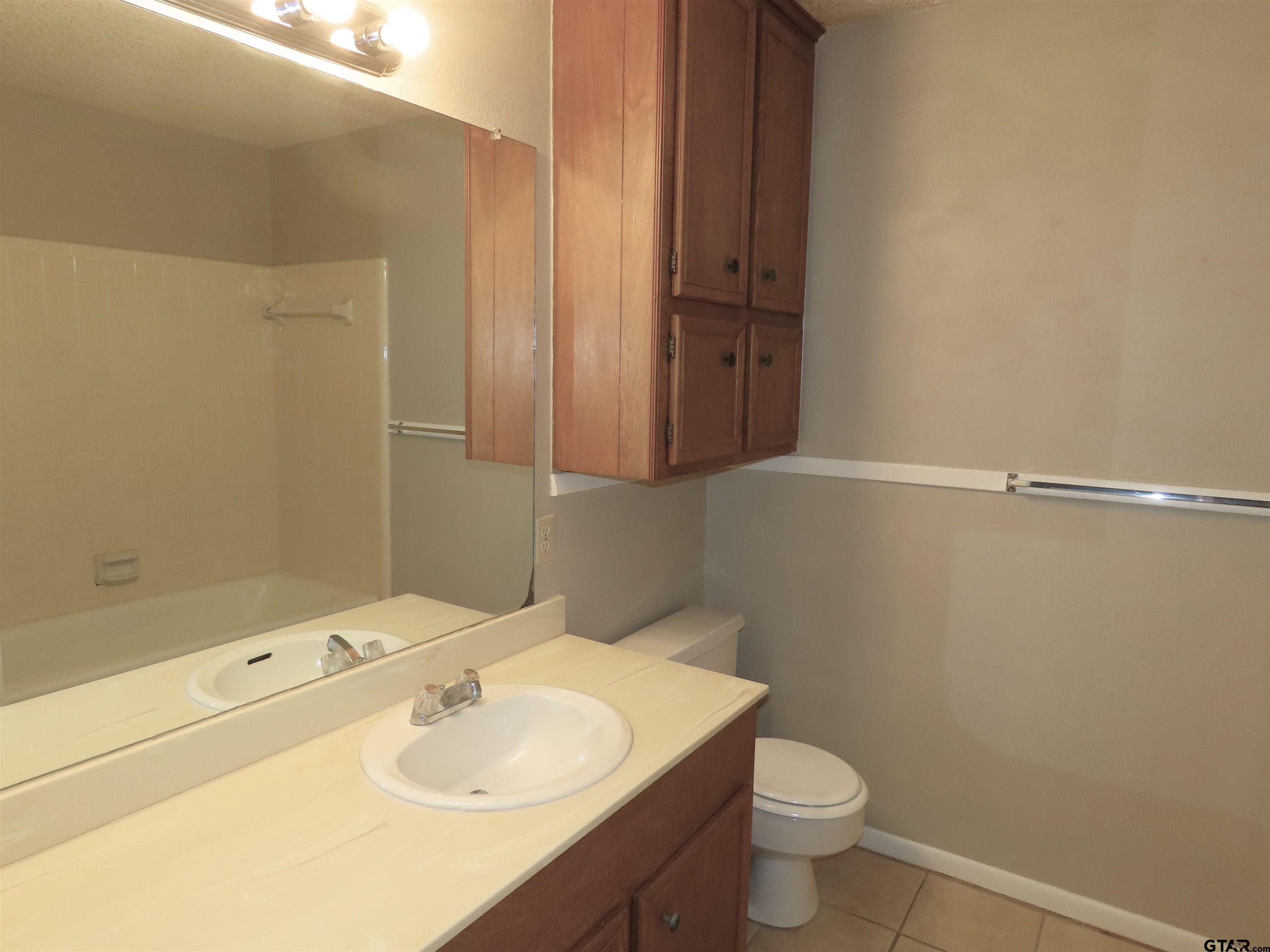 402 Muller Garden Road Tyler, TX 75703 - Photo 26 of 33 a bathroom with a sink a toilet and shower