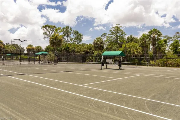a view of a tennis court with a large pool