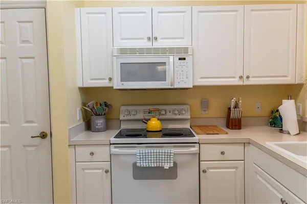 a kitchen with sink cabinets and appliances