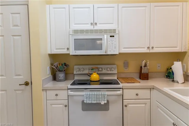 a kitchen with sink cabinets and appliances