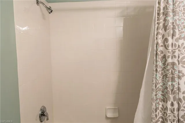 a living room with furniture and a painting on the wall