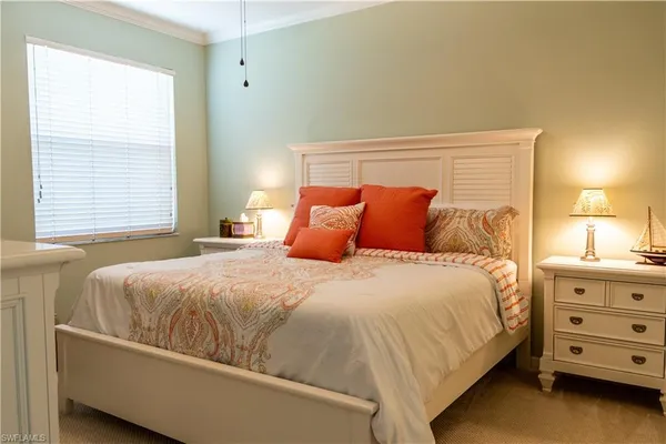 a bedroom with a bed and a dresser in it