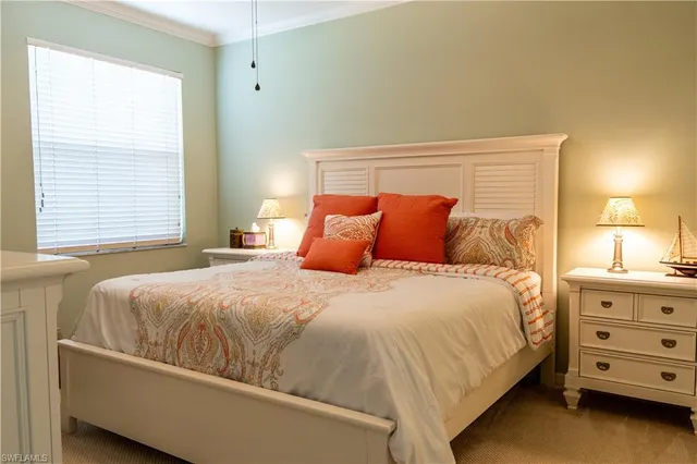 a bedroom with a bed and a dresser in it