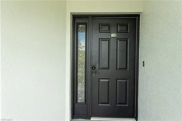 a view of a building with car parked