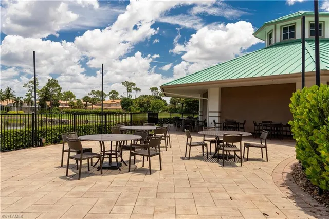 a view of a house with sitting area and swimming pool