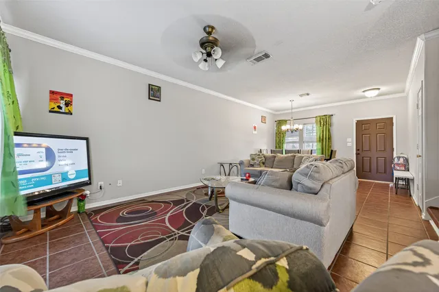 a living room with furniture a couch and a flat screen tv
