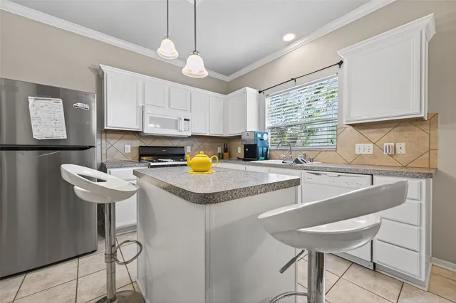 a kitchen with a sink cabinets and window