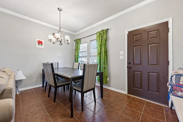a view of a dining room with furniture and chandelier