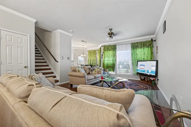 a living room with furniture ceiling fan and a rug