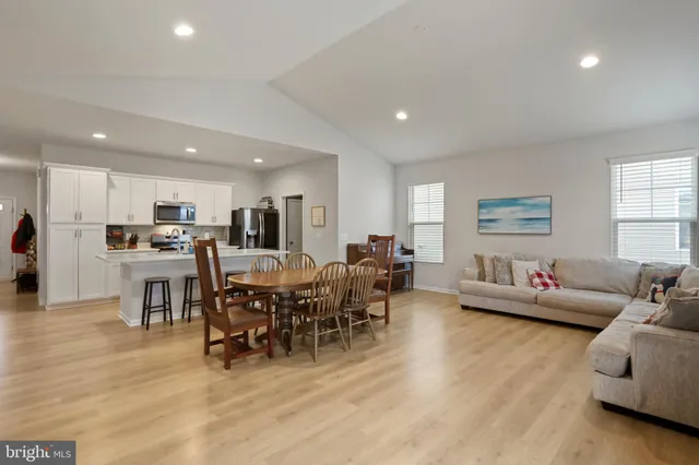 a living room with lots of furniture and kitchen view