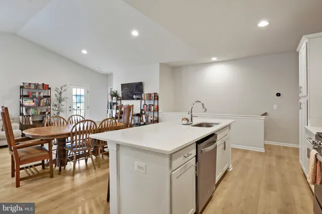 a kitchen with a table chairs and a refrigerator