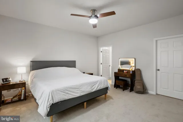 a large bed sitting in a bedroom and table