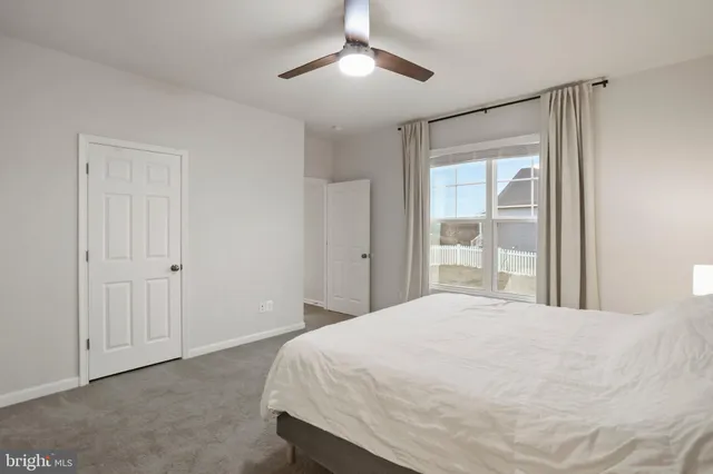 a spacious bedroom with a bed and a chandelier