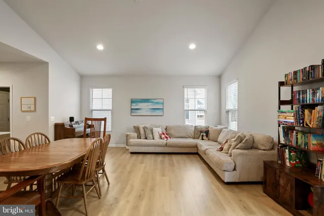 a living room with furniture and a book shelf
