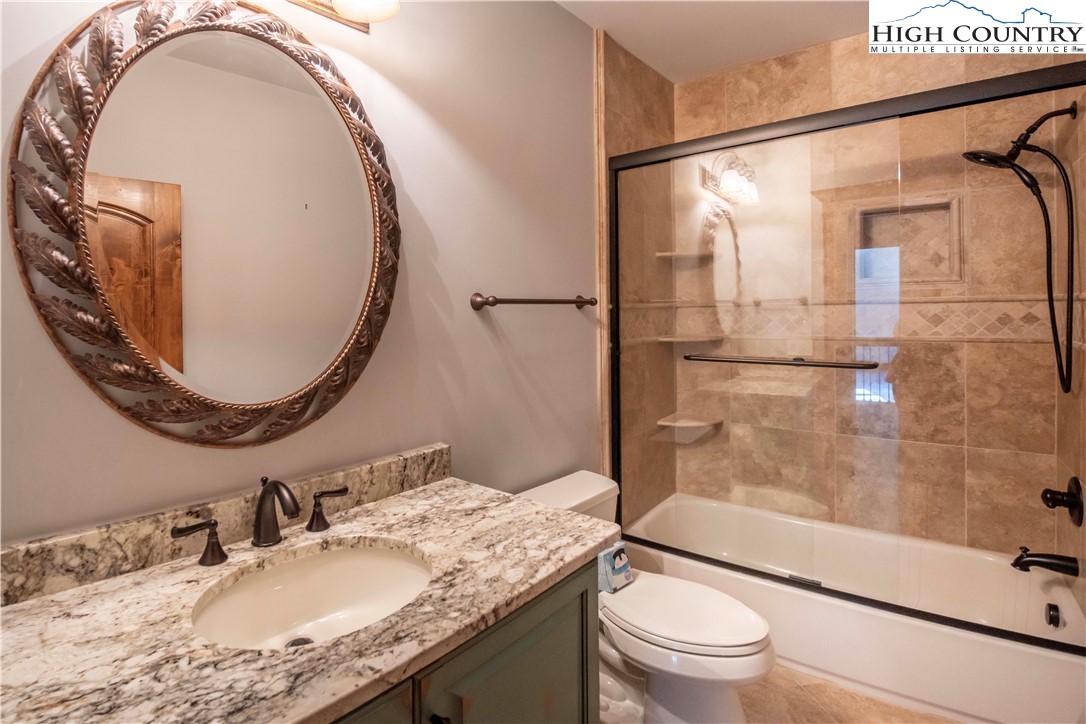 171 Acanthus Trail Boone, NC 28607 - Photo 23 of 49 a bathroom with a granite countertop sink toilet mirror and shower