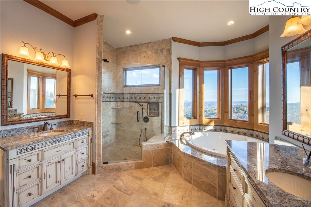 171 Acanthus Trail Boone, NC 28607 - Photo 31 of 49 a spacious bathroom with a granite countertop tub sink and mirror