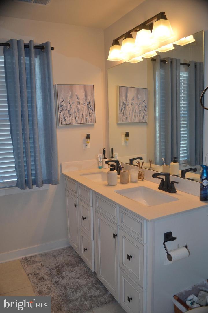 1015 Rampart Drive Fredericksburg, VA 22401 - Photo 18 of 37 a bathroom with a double vanity sink and a mirror
