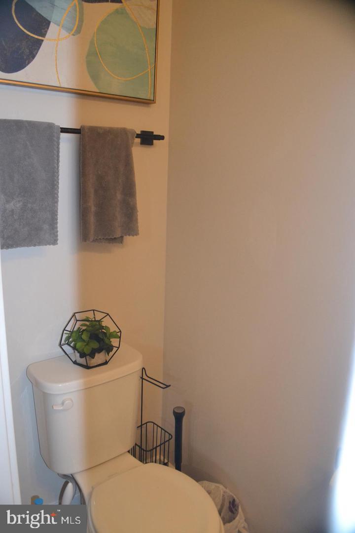 1015 Rampart Drive Fredericksburg, VA 22401 - Photo 27 of 37 a white toilet sitting next to a white sink and vanity