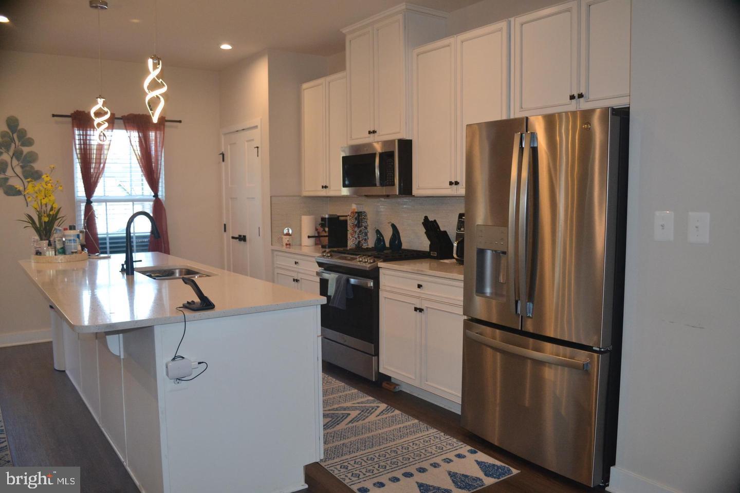 1015 Rampart Drive Fredericksburg, VA 22401 - Photo 9 of 37 a kitchen with stainless steel appliances a refrigerator a sink a stove and cabinets