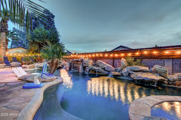 a view of a swimming pool with outdoor seating