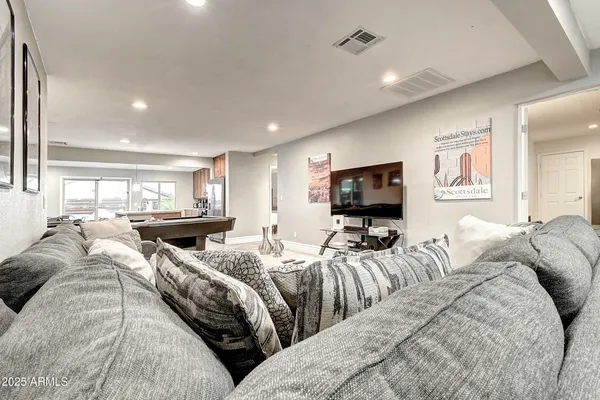 a large kitchen with kitchen island a large counter space dining table and stainless steel appliances