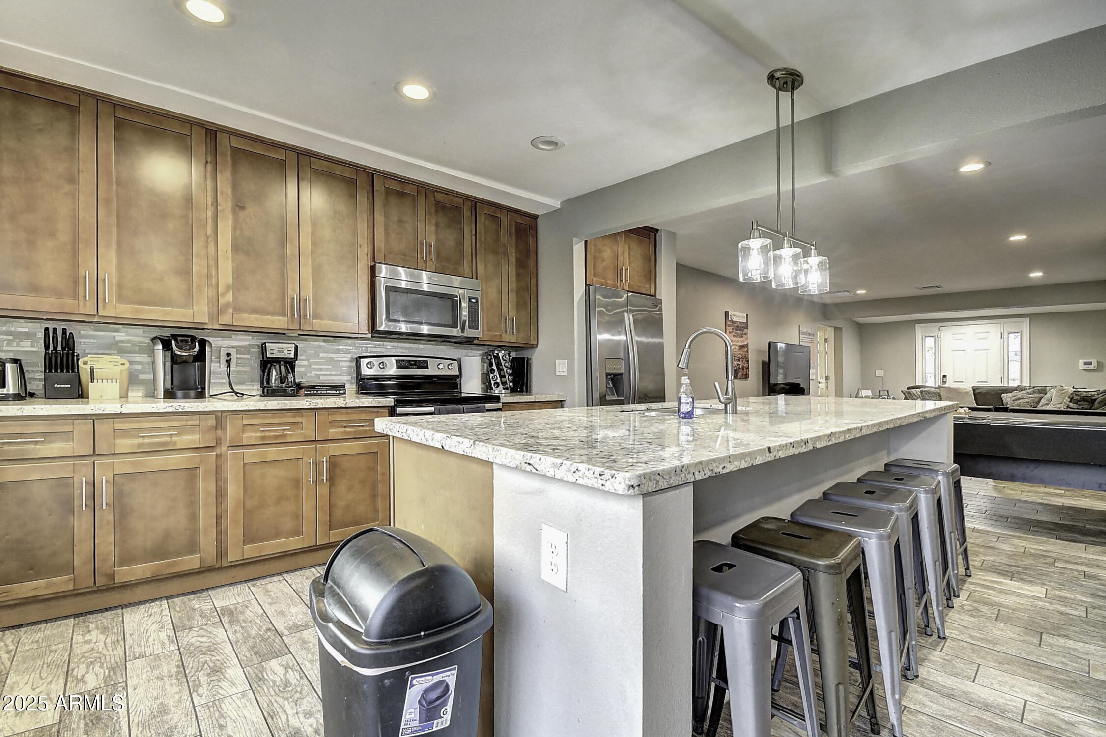 4101 East Nisbet Road Phoenix, AZ 85032 - Photo 29 of 64 a kitchen with stainless steel appliances granite countertop a stove a sink and a refrigerator