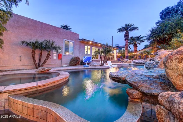 a view of a backyard with a patio and fire pit