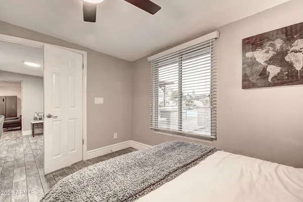 a bedroom with a bed and a tv on dresser