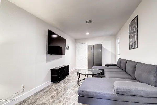 a bedroom with a large bed and a flat screen tv