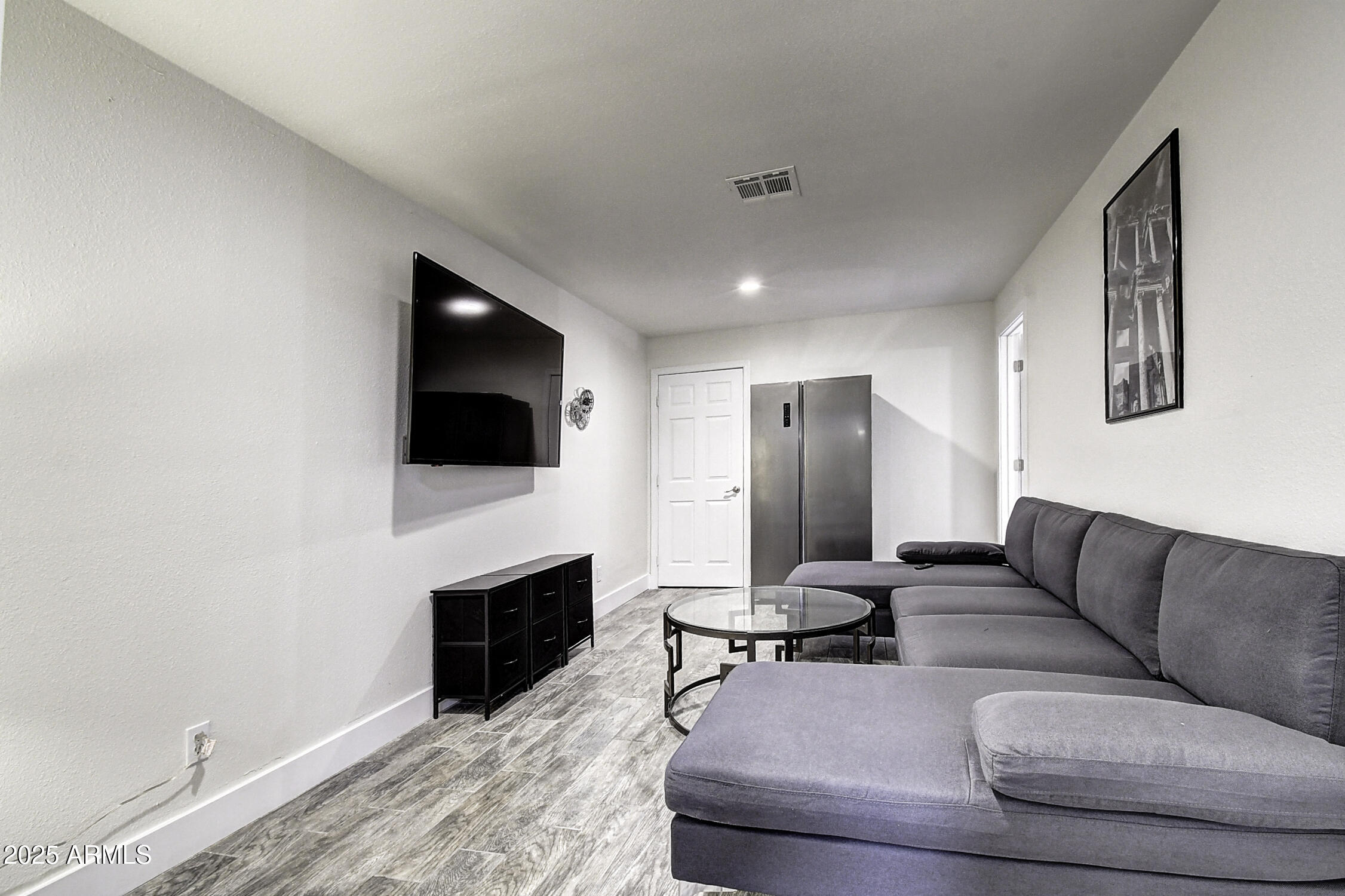 4101 East Nisbet Road Phoenix, AZ 85032 - Photo 47 of 64 a living room with furniture a flat screen tv and a fireplace