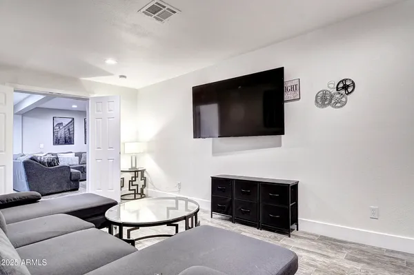 a bedroom with a bed and a flat screen tv