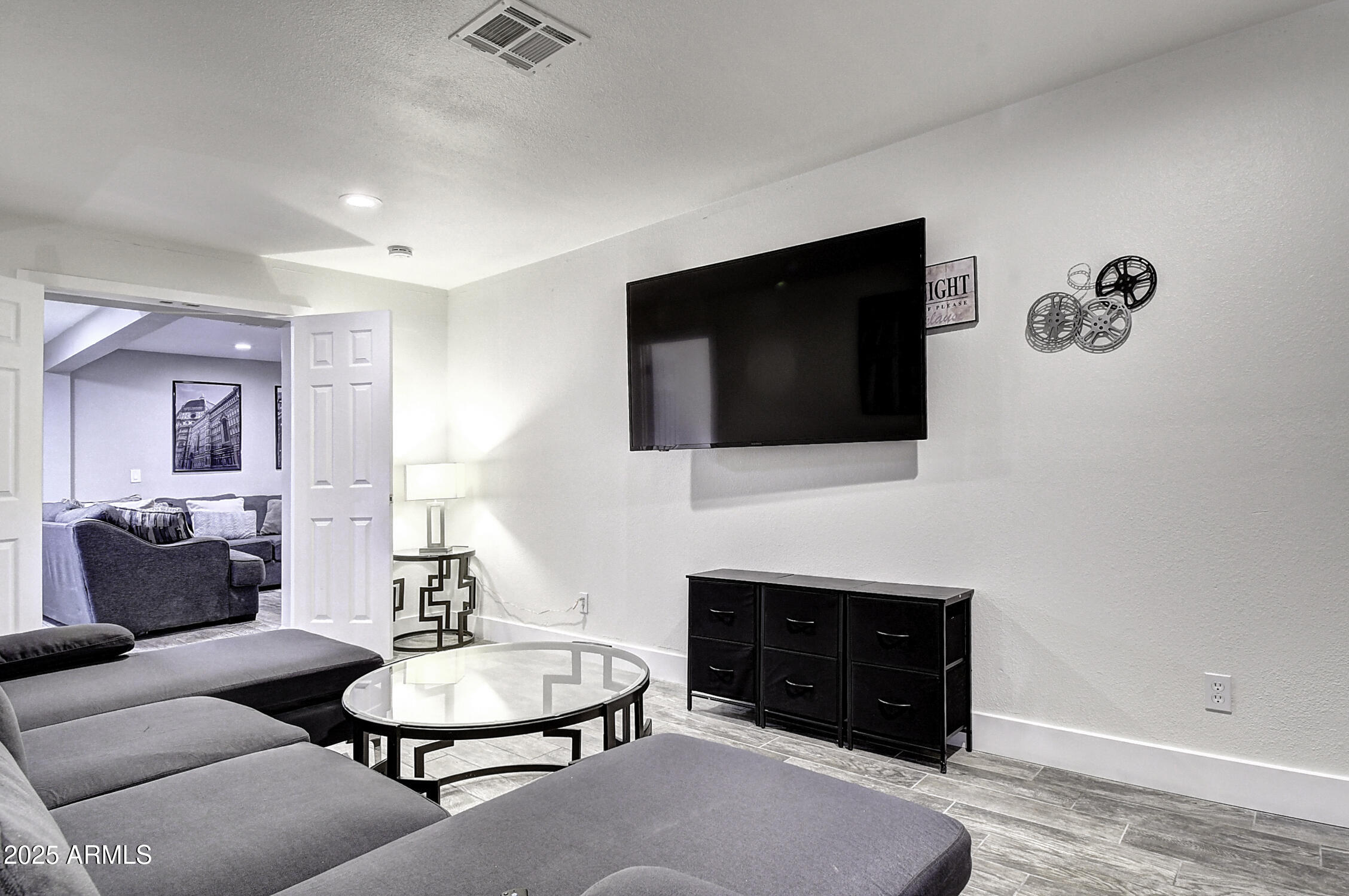 4101 East Nisbet Road Phoenix, AZ 85032 - Photo 48 of 64 a living room with furniture a fireplace and a flat screen tv