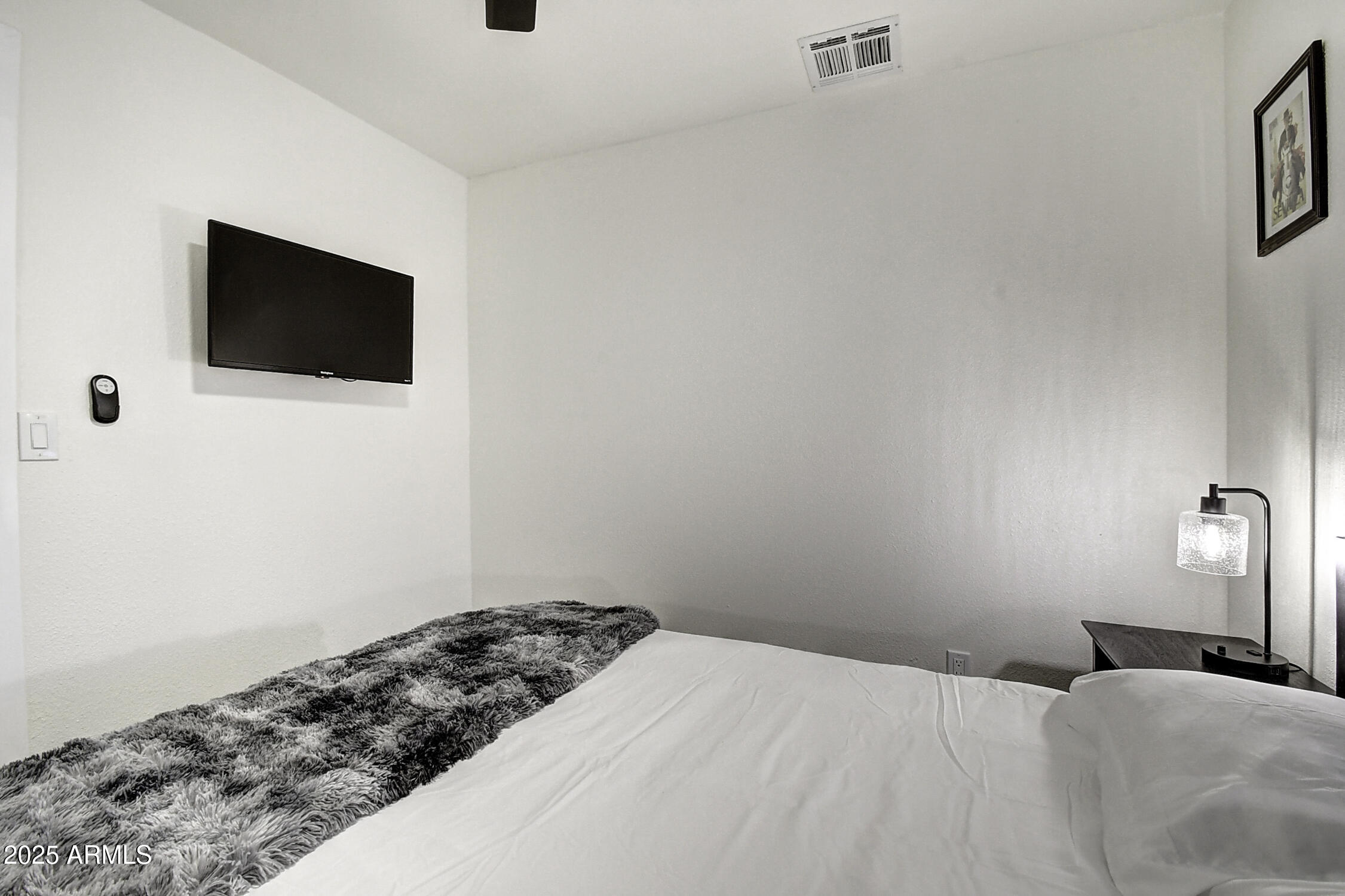 4101 East Nisbet Road Phoenix, AZ 85032 - Photo 52 of 64 a bedroom with a bed and a flat screen tv