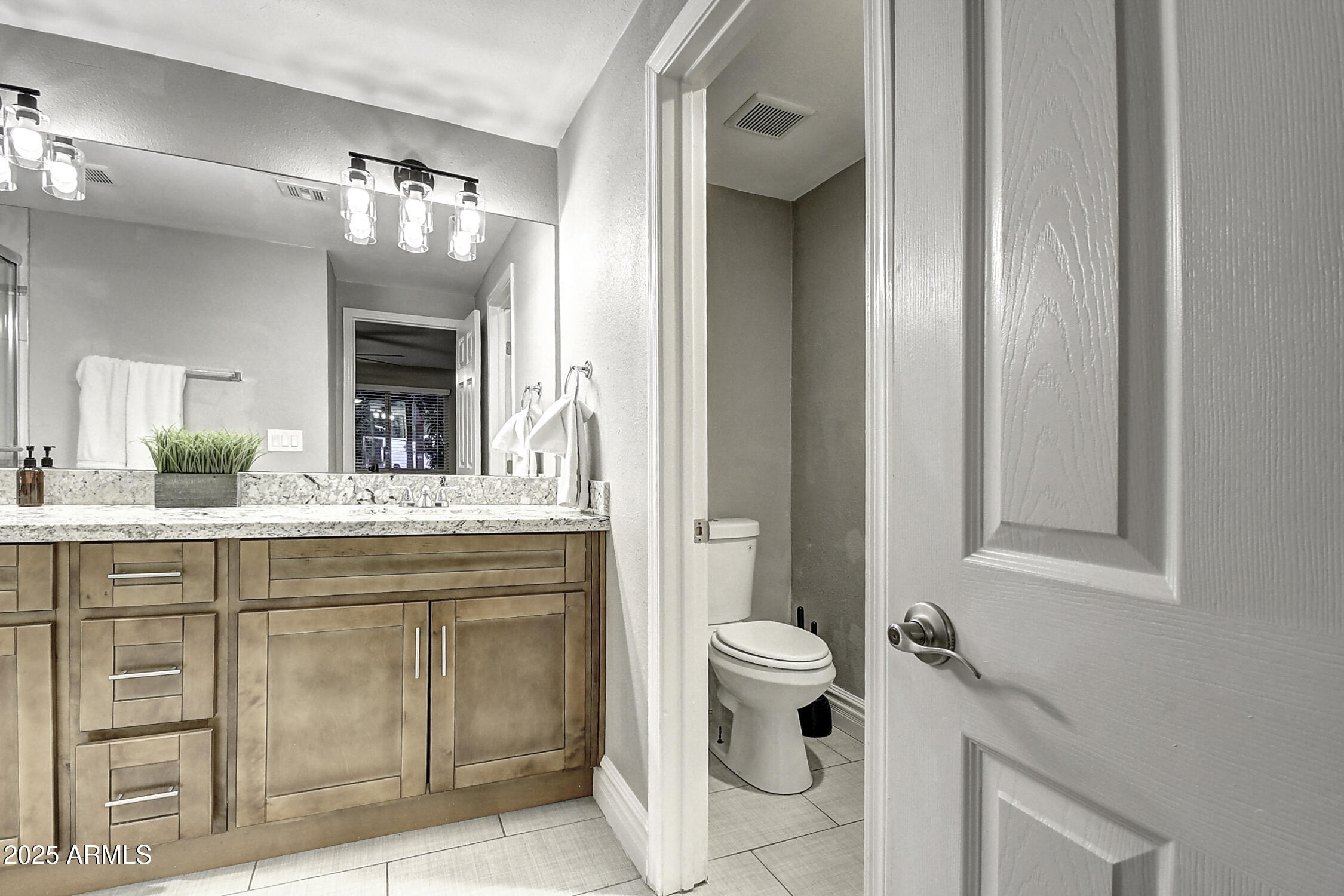 4101 East Nisbet Road Phoenix, AZ 85032 - Photo 58 of 64 a spacious bathroom with a granite countertop sink a toilet and a mirror